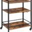 INDIAN DECOR 61205 Bar Cart for The Home, Serving Cart with Wine Glasses Hooks, Rolling Kitchen Cart with Lockable Wheels, Beverage Cart with Storage Shelves, Adjustable Feet, Industrial, Rustic Brown