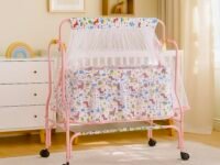 Amazon Brand - Supples Baby Cradle with Swing & Mosquito Net | 0–8 Months | Swing Lock | 4 Wheels with Brake | Soft & Comfortable for Baby Sleep | Sturdy Mild Steel Frame | Pink