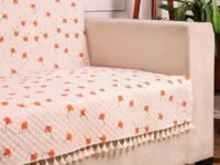 STITCHNEST Quilted Velvet Sofa Cover with Tassels – 70x60 Inch, Orange Floral Print with Stripes, Soft & Elegant, Washable Sofa Protector for 3-Seater